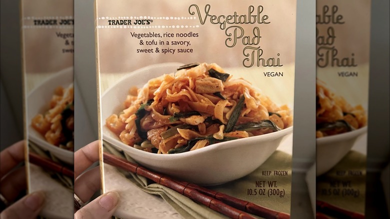 Hand hols a box of Trader Joe's Vegetable Pad Thai