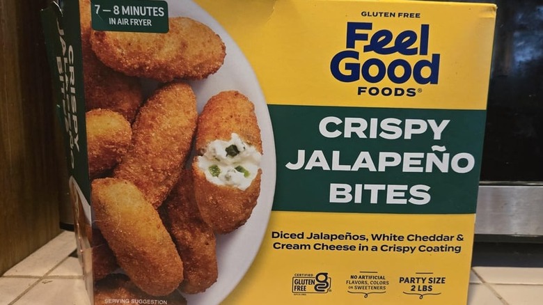 A box of Feel Good Foods Crispy Jalapeño Bites in front of a microwave