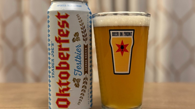 A can of Trader Joe's Oktoberfest Festbier next to a full pint glass