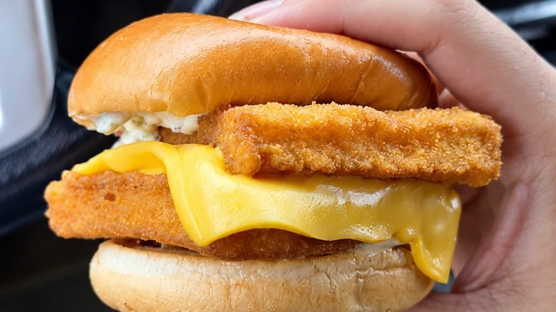 customer holding McDonald's fish sandwich