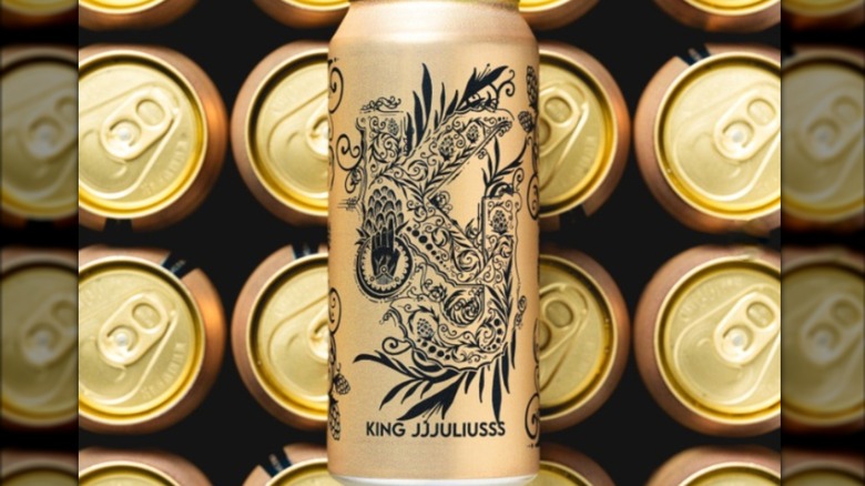 A gold can of King Jjjuliusss beer against the backdrop of can tops.