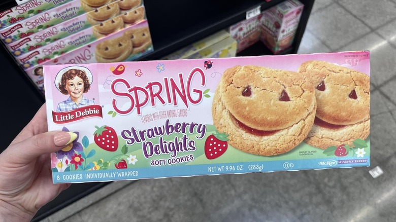 Hand holding box of Little Debbie Strawberry Delights Soft Cookies