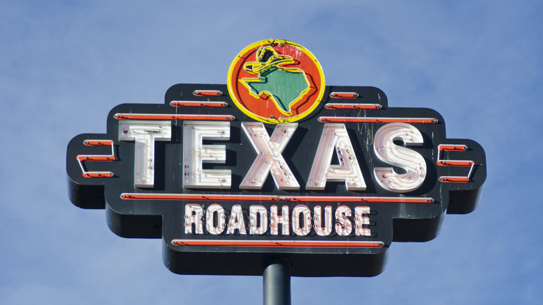 Texas Roadhouse sign in front of blue sky