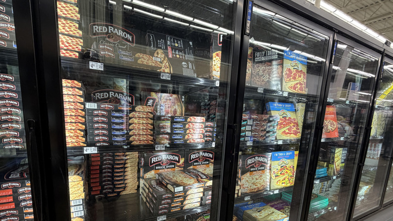 Freezers full of pizzas in a Walmart frozen food section