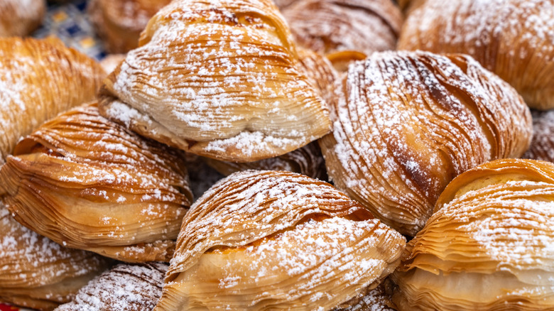 Plate of sfogliatella, known as lobster tails, dusted with sugar