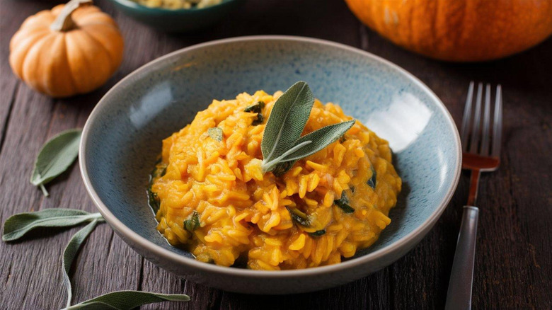 Bowl of pumpkin risotto with sage leaves on top