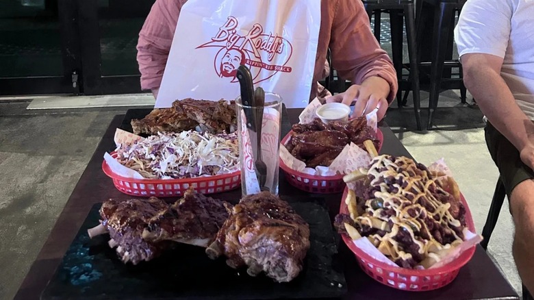Food challenge with BBQ ribs, wings, poutine, and coleslaw