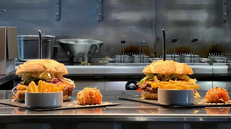Two Huggys burger challenges on table in kitchen