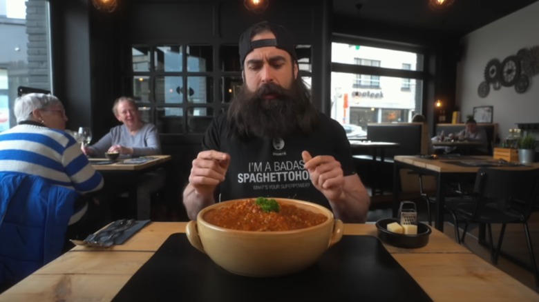 Adam Moran at a table taking on the pasta challenge at Mister Spaghetti