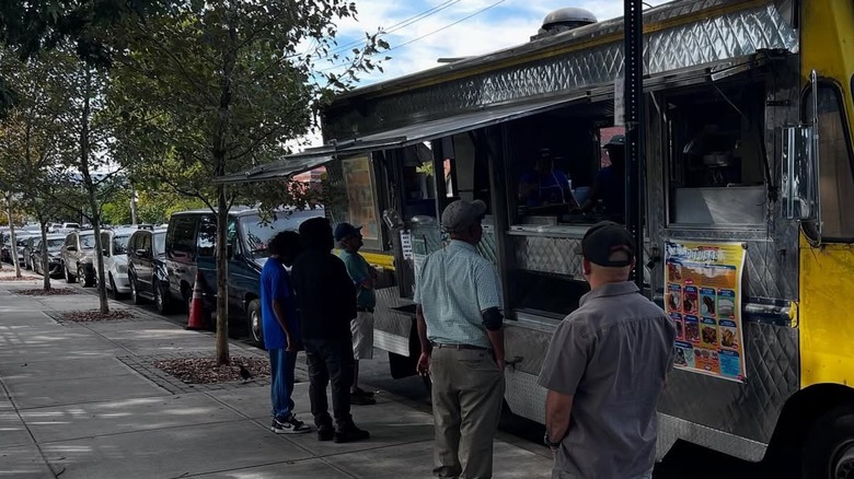 People standing in front of food truck