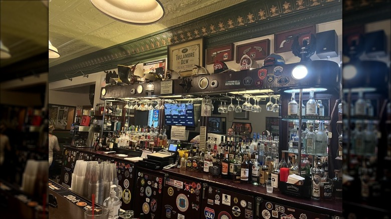 Nancy Whiskey bar covered with patches, bottles, stickers, and signs