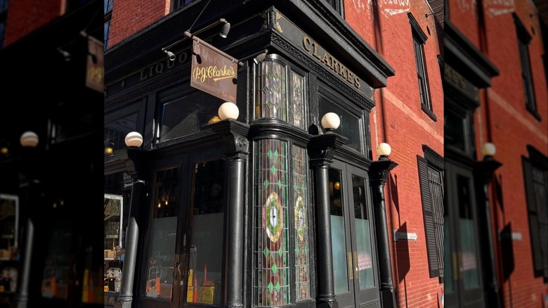 Exterior of PJ Clarke's with stained class and signage