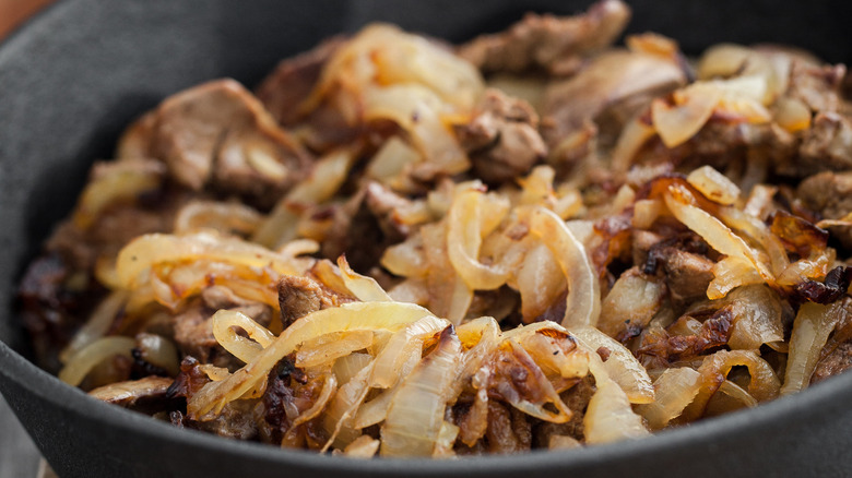 Close up of dish of liver and onions in a cast skillet