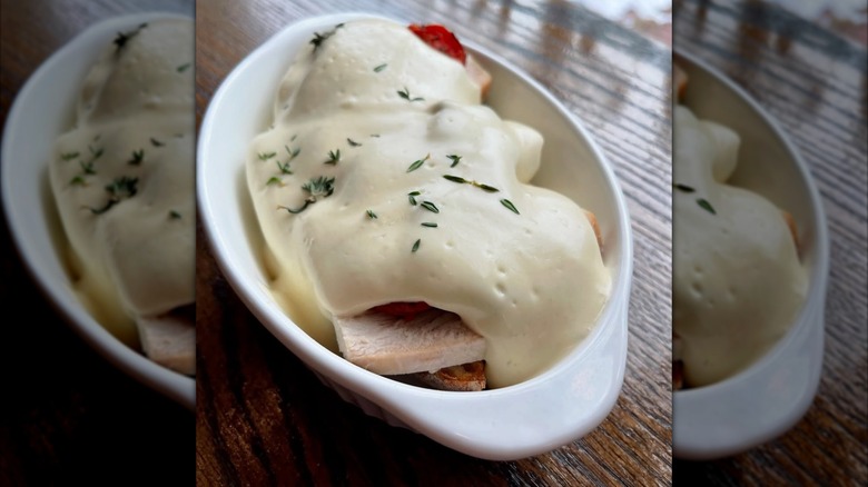 Mirrored image of turkey devonshire in white dish