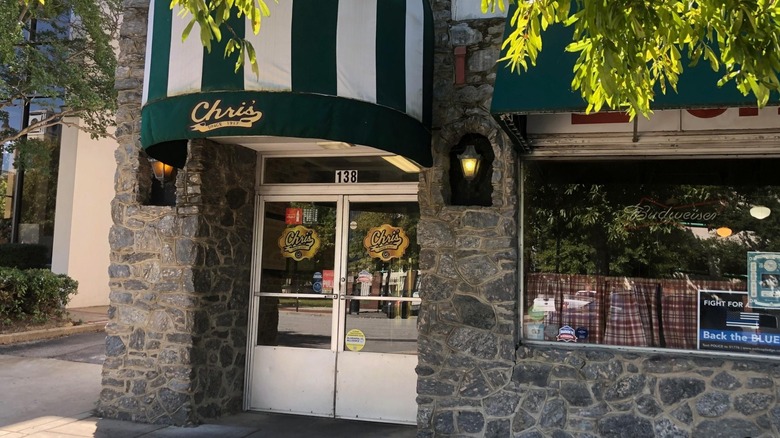 Exterior of Chris's stone building with large front window