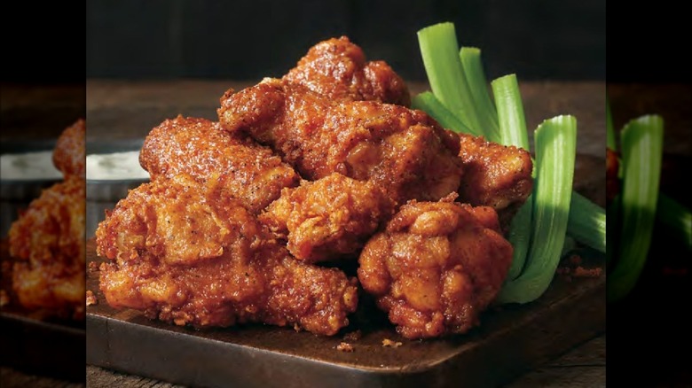 Outback Steakhouse Kookaburra Wings next to celery sticks on wooden board