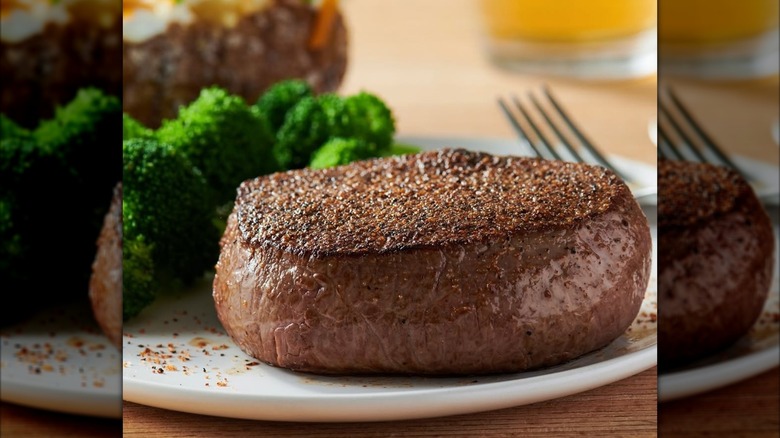 Center Cut Sirloin steak from Outback Steakhouse on white plate next to broccoli