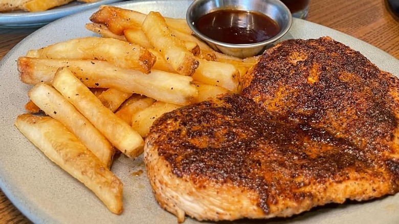 Grilled Chicken on the Barbie with french fries and silver cup of sauce from Outback Steakhouse