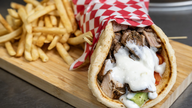 Gyros on cutting board with fries