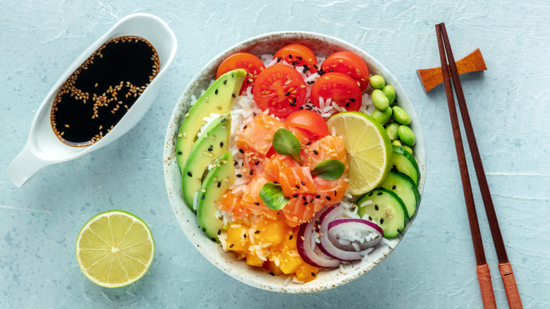 Colorful poke bowl with raw fish, rice, and veggies