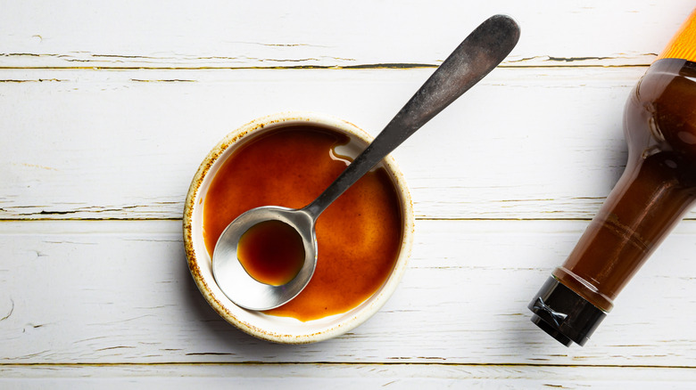 Worcestershire sauce in small bowl with spoon