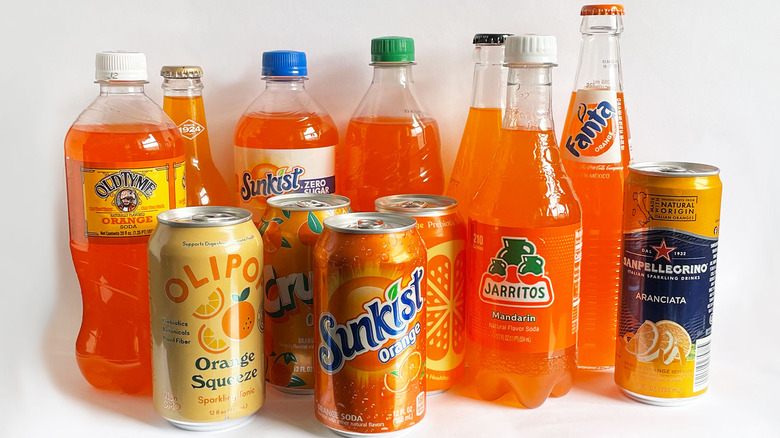 Orange soda bottles and cans
