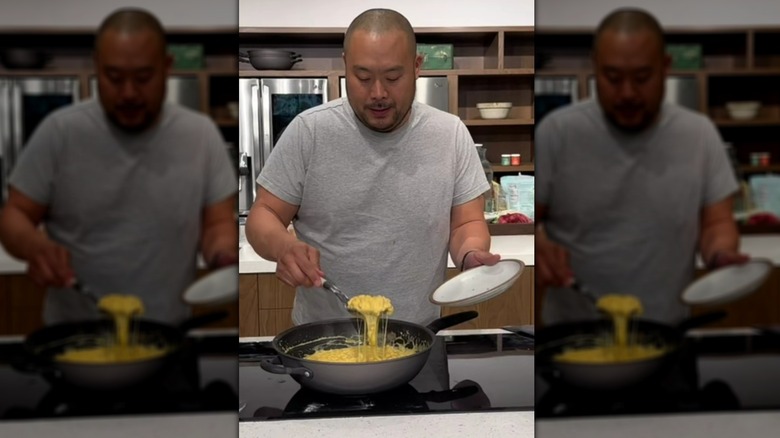 Chef David Chang spooning mac and cheese out of wok