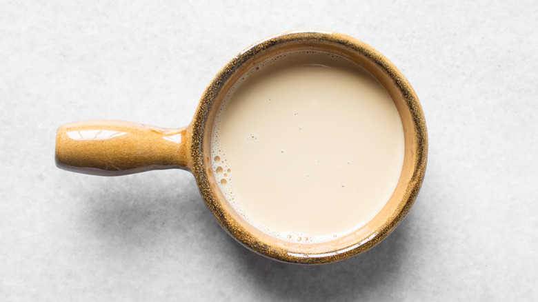 Evaporated milk in brown bowl with handle