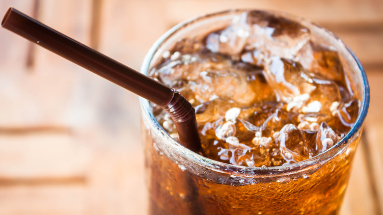 Close up of soda with ice and a straw