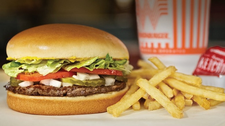 A promotional with a hamburger and fries from Whataburger