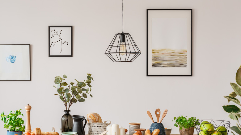 Various art prints on white kitchen walls