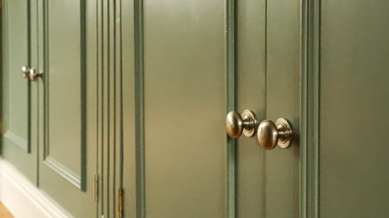 Knobs on sage green kitchen cabinets