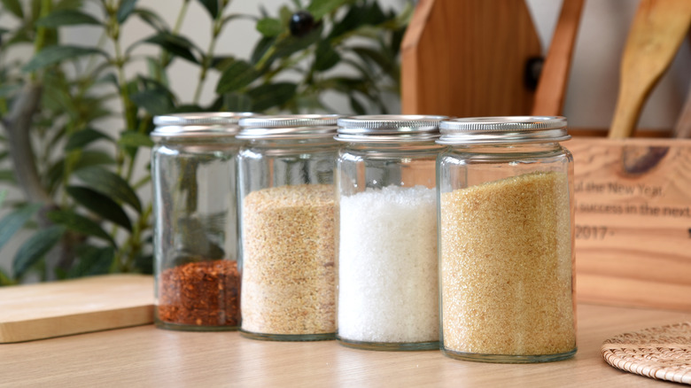 Decorative jars with seasonings on kitchen countertop