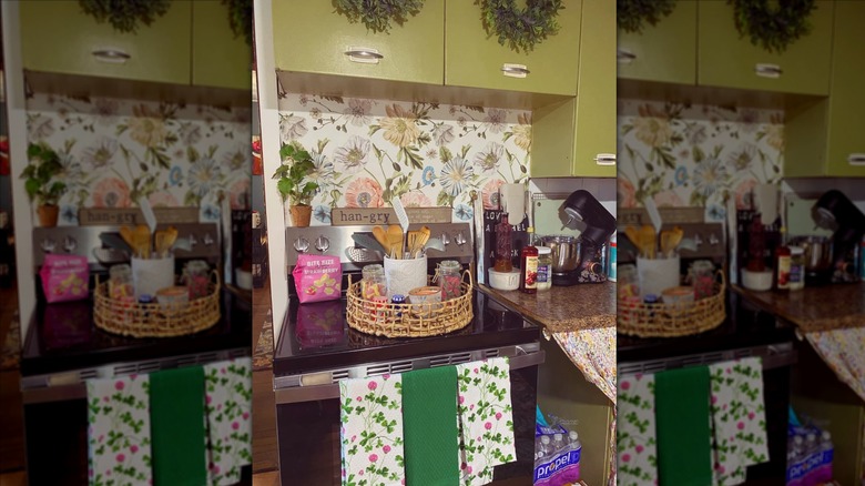 Green kitchen with colorful wallpaper