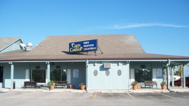 Old photo of Cap'n and the Cowboy restaurant in front of empty parking lot