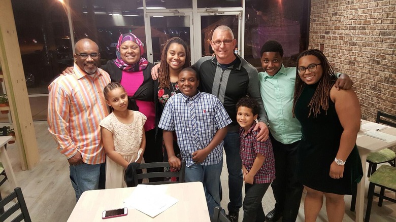 Robert Irvine with the family behind So Natural, inside the restaurant