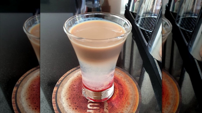 Mirrored image of slippery nipple shot on beer mat