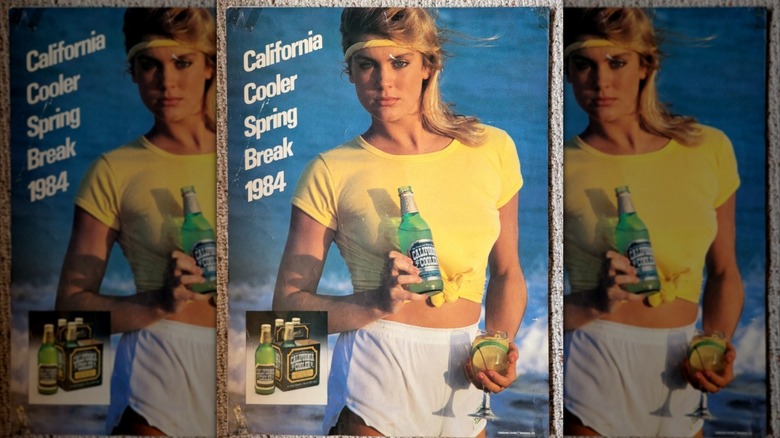 vintage California Cooler poster featuring a woman on a beach holding a bottle next to the words "california cooler spring break 1984" mirrored image