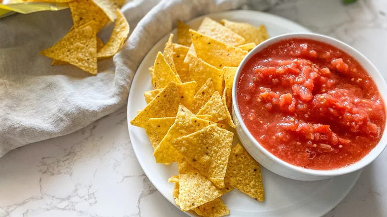 Copycat Chili's Salsa in white bowl next to tortilla chips