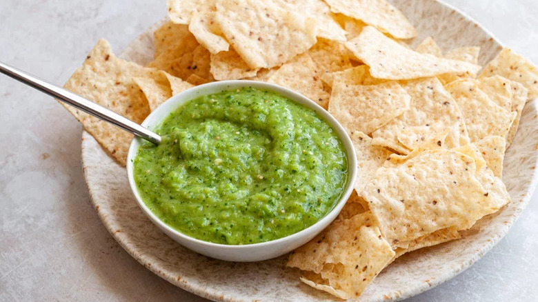 Creamy Salsa Verde in white bowl next to tortilla chips