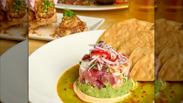 The Cheesecake Factory's ahi tuna and shrimp ceviche on table with dishes blurred in background