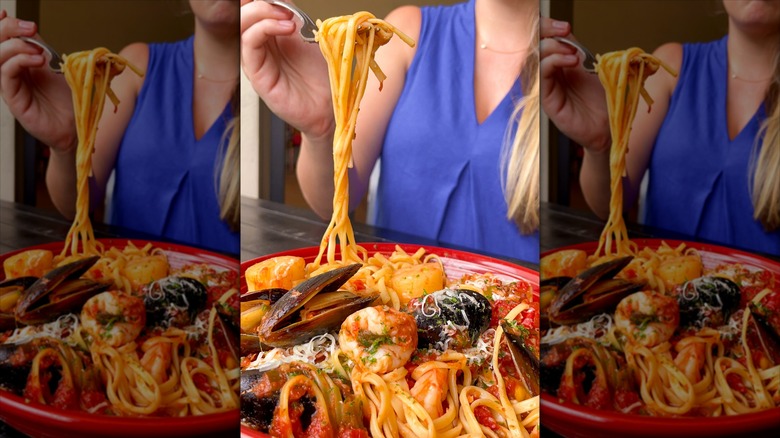 Unidentified person taking a forkful of Carrabba's Italian Grill's Linguine Pescatore