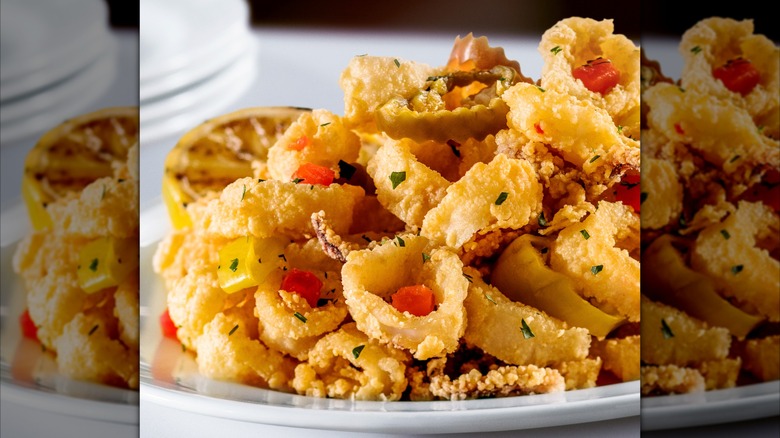 The Capital Grille's Pan-Fried Calamari with Hot Cherry Peppers on white plate and tablecloth