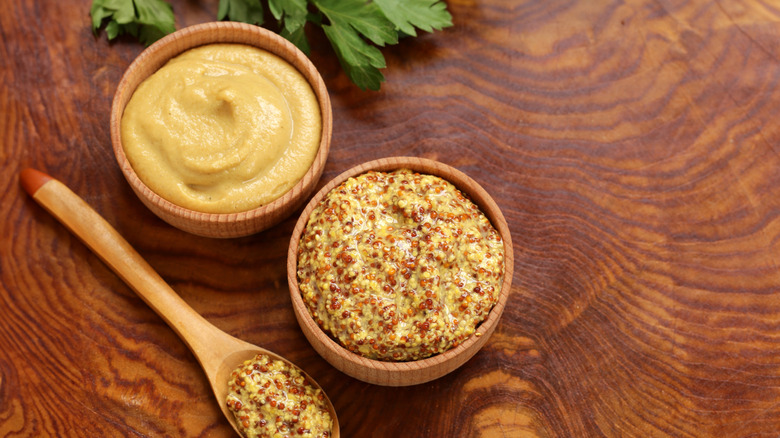 Small bowls of seeded and smooth Dijon mustard