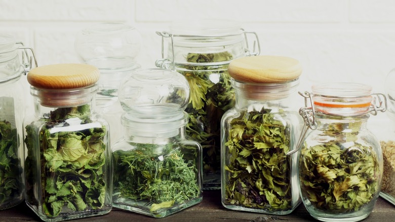 Glass jars of dried herbs