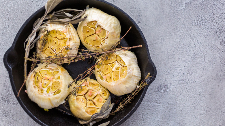 Heads of roasted garlic in small skillet
