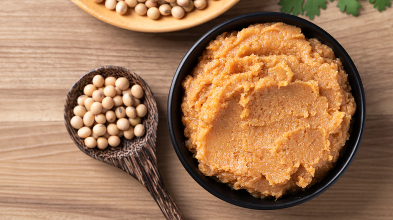 Bowl of white miso paste with dried soy beans