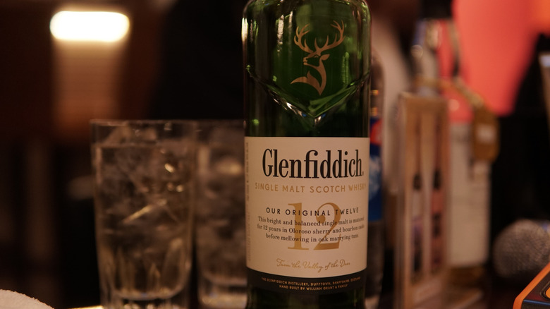 A close up of a bottle of Glenfiddich 12, showing how it states it's a single malt whisky