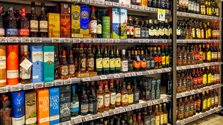 A view of the whiskey section of a liquor store, showcasing a wide selection of bottles