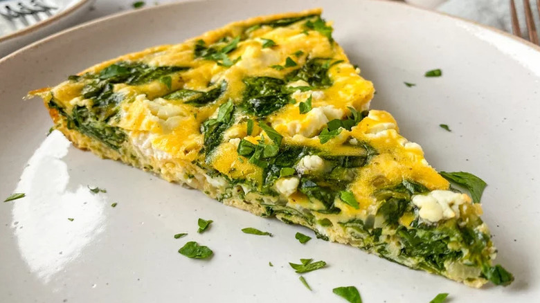 slice of spinach frittata on white plate